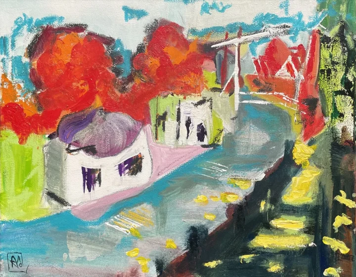 Schepenmakersdijk Edam: een huisje aan het water met bomen in rood en oranje en een ophaalbrug.
